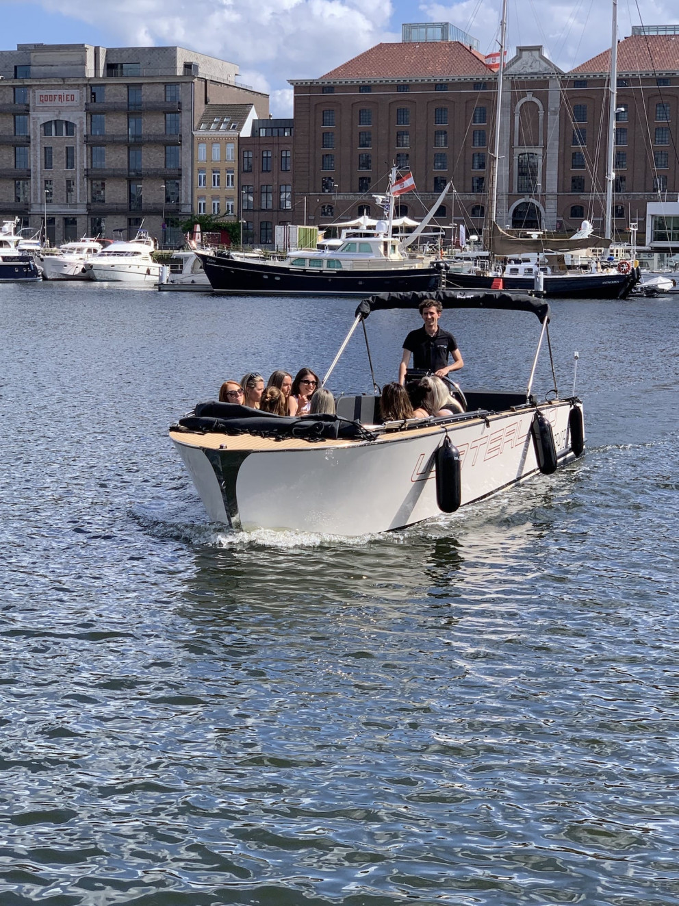 Waterlimo conducting a boat tour with their sloop in the city harbor of Antwerp near the MAS